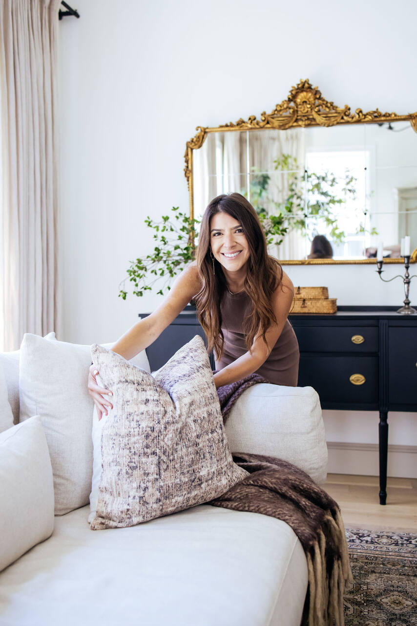Danielle, founder of SageHouse Staging, in a styled living room